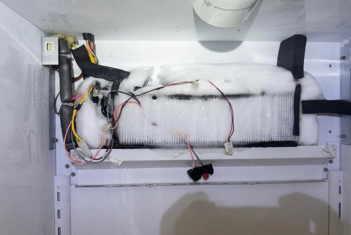Sub-Zero evaporator coils completely iced over — blocked airflow causing refrigerator not cooling